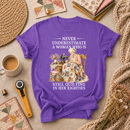Never Underestimate A Woman Still Quilting T-Shirt - Heather Team Purple